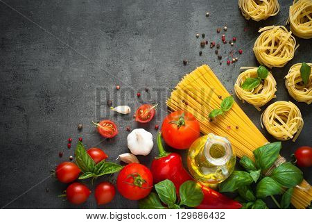 Ingredients for cooking Italian pasta - spaghetti tomatoes basil and garlic. Top view with space for taxt.