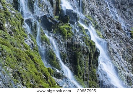 Waterfall at talc quarry among the mossy stones