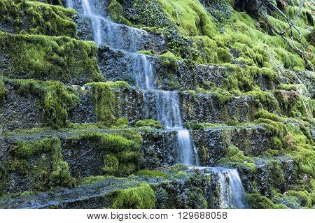 Waterfall at talc quarry among the mossy stones