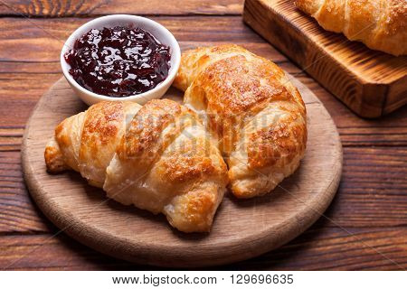 Two  delicious croissants on a wooden cutting board
