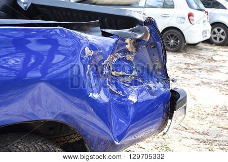 A wrecked car lays in wait after a vicious car accident. 