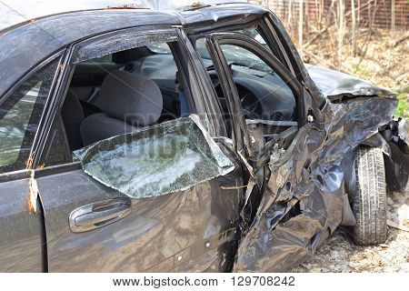 A wrecked car lays in wait after a vicious car accident. 