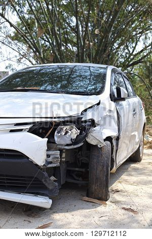 A wrecked car lays in wait after a vicious car accident. 