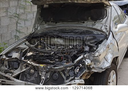 A wrecked car lays in wait after a vicious car accident. 
