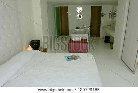 HERAKLION, CRETE, GREECE - MAY 13, 2014: The Interior room with big bed and bath in modern building of luxury class hotel on the Mediterranean coast of Crete, May 13, 2014, Greece.
