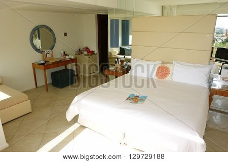 HERAKLION, CRETE, GREECE - MAY 13, 2014: The Interior room with big bed in modern building of luxury class hotel on the Mediterranean coast of Crete, May 13, 2014, Greece.