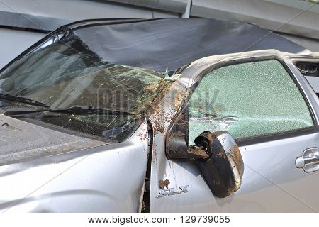 A wrecked car lays in wait after a vicious car accident. 