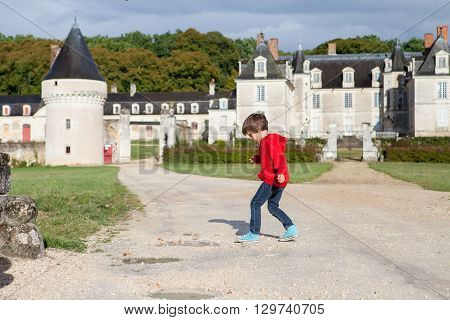 Two Boys, Happily Playing After The Rain On The Driveway Of French Gizeux Castle