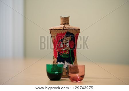 an italian liqueur and two colored glasses