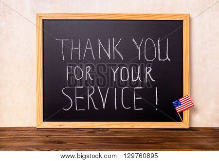 Handwriting Text Thank You For Your Service With Flag Of United States Is Written In Chalkboard On W