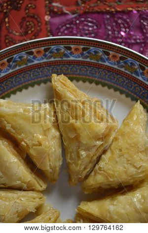 An oriental sweet dish - Baklava. a puffed pastries in a plate. Partial view from above.
