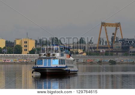 KIEV,UKRAINE - MAY 15, 2016: Pleasure boats on the Dnepr River and river shore in historical area. Kiev. Ukraine