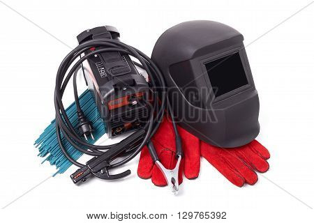 Inverter welding machine, welding equipment, isolated on a white background, welding mask, leather gloves, welding electrodes, high-voltage wires with clips, set of accessories for arc welding.