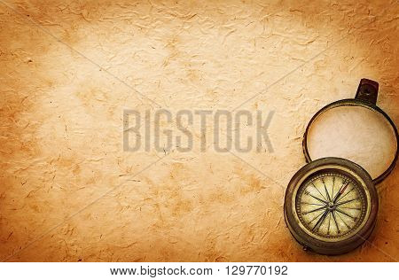 Ancient Brass Compass On Vintage Old Paper Background. Retro Stale.