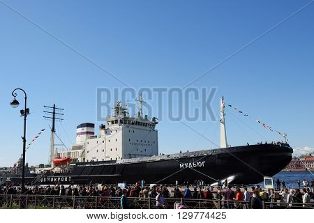 ST. PETERSBURG, RUSSIA - MAY 2, 2016: People waiting in line on English embankment for visit the icebreaker Mudyug during 3rd Icebreaker Festival. It's unique fest dedicated to icebreaker fleet