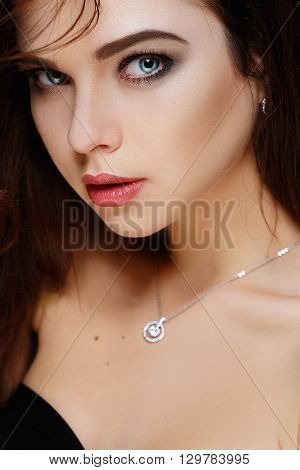 Sexy Beauty Girl with Red Lips. Make up. Luxury Woman with Long Curly Hair. Fashion Brunette Portrait isolated on a grey background. Gorgeous Woman Face.