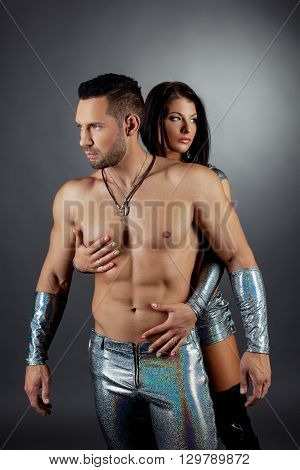 Strip show. Image of bearded man and sexy brunette posing