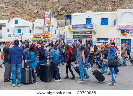 Santorini, Greece - May 2, 2016: Meeting tourists at the dock in the sea port of Santorini Athinios. Santorini is part of the five most visited tourist destinations in the world.
