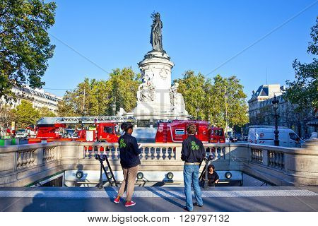 Paris France - September 29 2011: People in Place de la Republique with the monument of Marianna in the background.