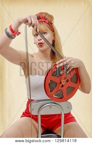 a sexy pin-up girl with a film reel