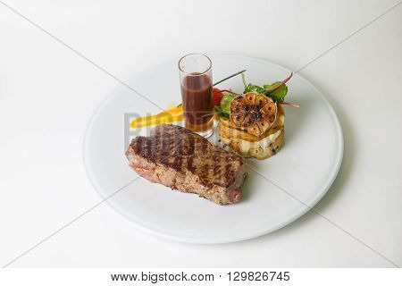 Juicy beef steak with sauce and garnich