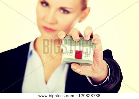 Aggresive business woman crushing small house