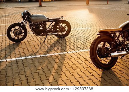 Two Black And Silver Vintage Custom Motorcycles Caferacers
