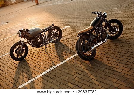 Two Black And Silver Vintage Custom Motorcycles Caferacers