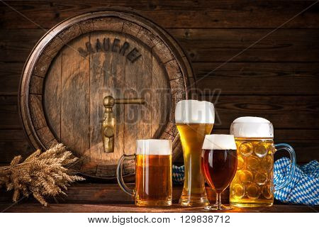 Beer barrel with beer glasses on wooden background