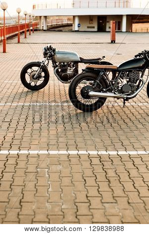 Two Black And Silver Vintage Custom Motorcycles Cafe Racers