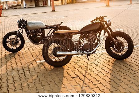 Two Black And Silver Vintage Custom Motorcycles Cafe Racers