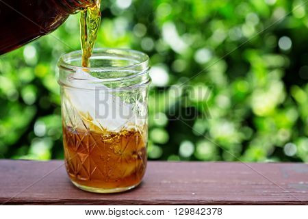 Iced coffee in mason jars outdoors on the front porch