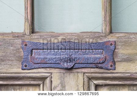 Antique letter mail box on old wood door