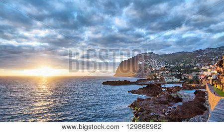 Sunset over Cabo Girao cliff viewed from Camara de Lobos Madeira Portugal