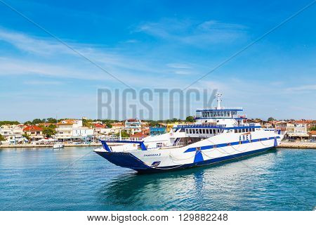 Keramoti, Greece - May 1, 2016: Keramoti port and town view with ferry boat going to Thassos island