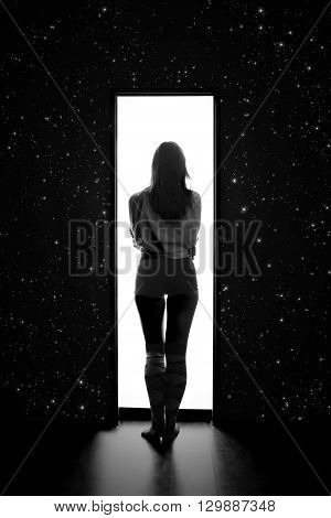 woman enter to white space from dark with stars monochrome image