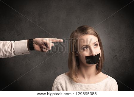 Caucasian business hand pointing at female employee with grunge background