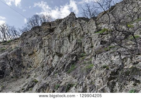 Mountainside of Lozen mountain with cliff and trees at the top, Pancharevo, Bulgaria