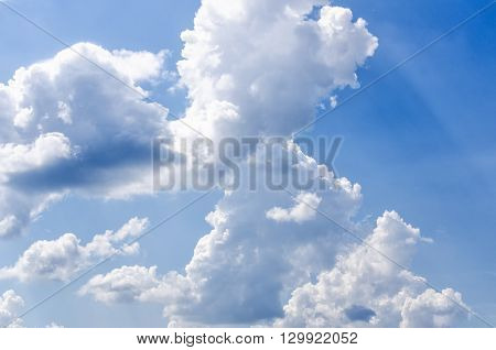 fluffy clouds on a blue sky with the sun