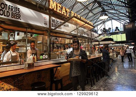 TEL AVIV, ISRAEL - APRIL 7, 2016 : People having lunch in a modern open kitchen restaurant in Sarona Market, Tel Aviv, Israel. Recently open Sarona Market became the most popular place in Tel Aviv.