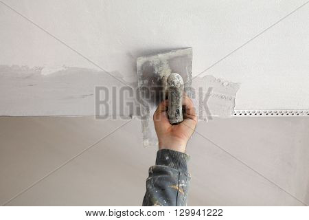Worker Install Batten At Ceiling And Wall