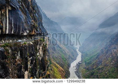 Car on dangerous road in Himalayas mountains in gorge above precipice