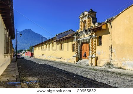 Agua volcano & typical cobblestone street in colonial city & UNESCO World Heritage Site of Antigua.