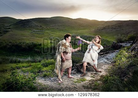 Caveman Couple In Love At Mountains