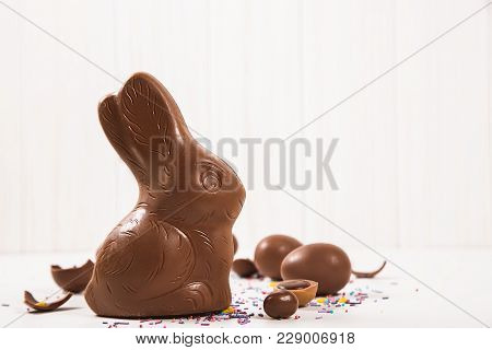 Easter Chocolate Bunny And Eggs On White Wooden Background