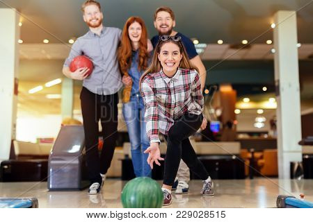 Friends Having Fun While Bowling And Speding Time Together