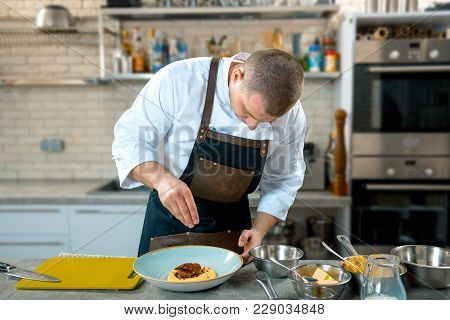 Food Cooking, Profession And People Concept - Male Chef Cook Serving Plate Of Polenta And Veal Tongu