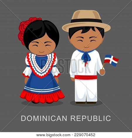 Dominicans In National Dress With A Flag. Man And Woman In Traditional Costume. Travel To Dominican 
