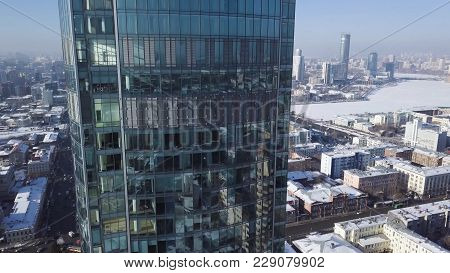 Close Up Of Windows Of Modern Skyscraper. Clouds Refelected In Modern Office Building. Zoom And Pann