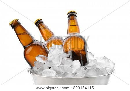 Bowl with bottles of beer in ice on white background
